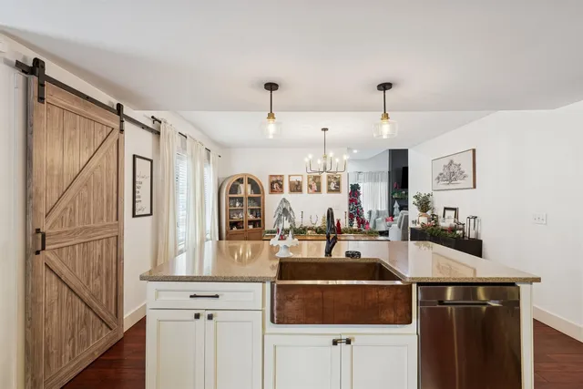 a kitchen with kitchen island a counter top space a sink and cabinets