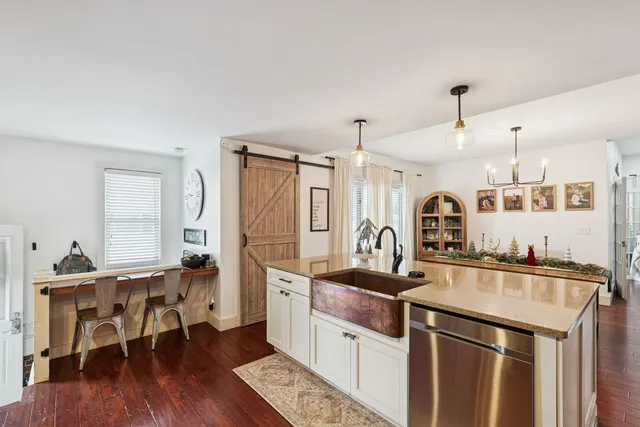 a kitchen with a sink stove and cabinets