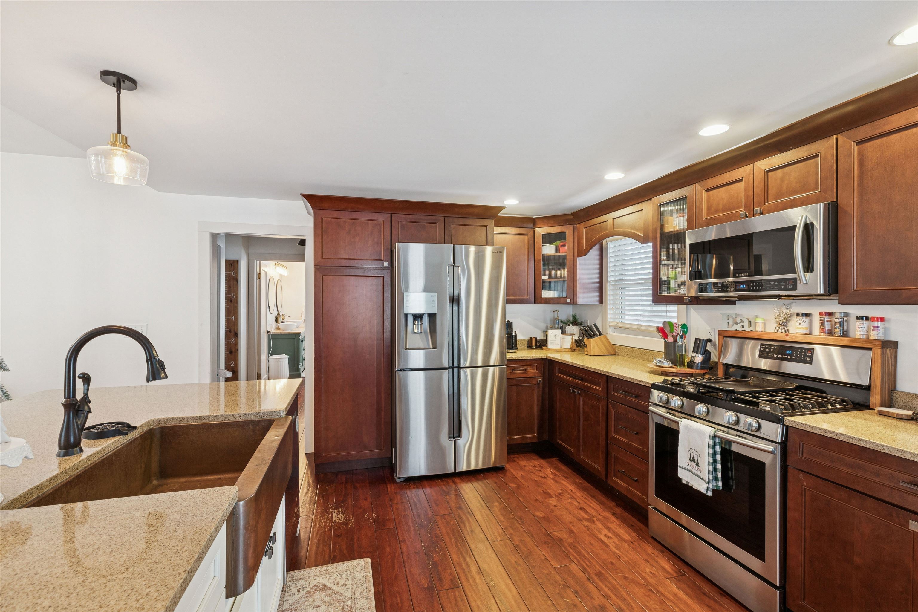 306 North Main Street Alexis, IL 61412 - Photo 26 of 44 a kitchen with stainless steel appliances granite countertop a refrigerator a stove top oven a sink and dishwasher with wooden floor