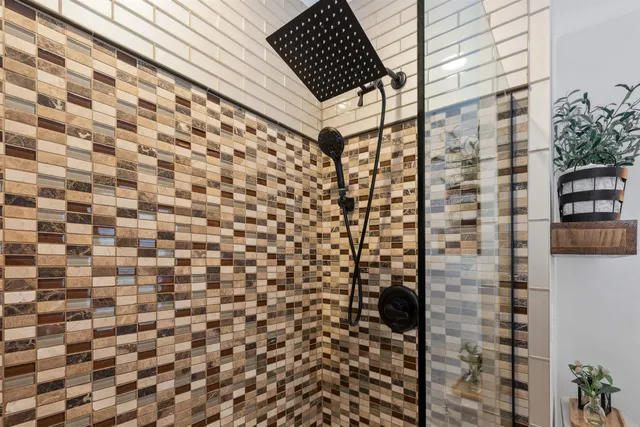 a bathroom with a shower and a shower