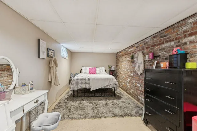 a bedroom with a bed and a dresser