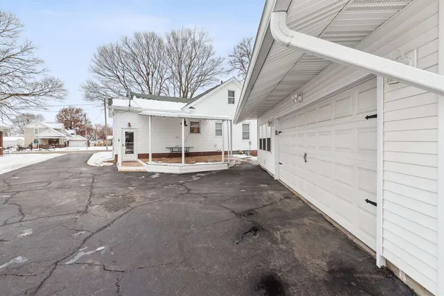 a view of a patio with table and chairs and floor to ceiling window