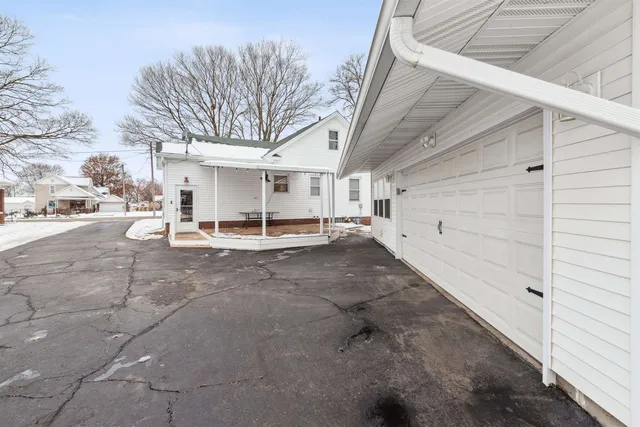 a view of a patio with table and chairs and floor to ceiling window