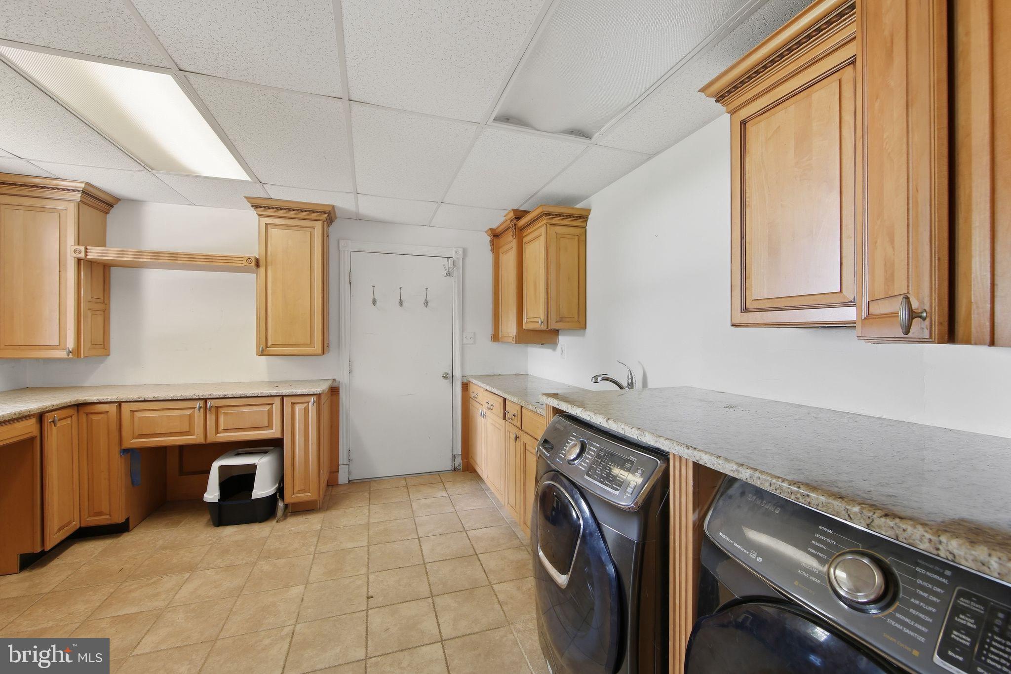 156 Grove Road Elverson, PA 19520 - Photo 12 of 45 a utility room with a sink a washer and dryer