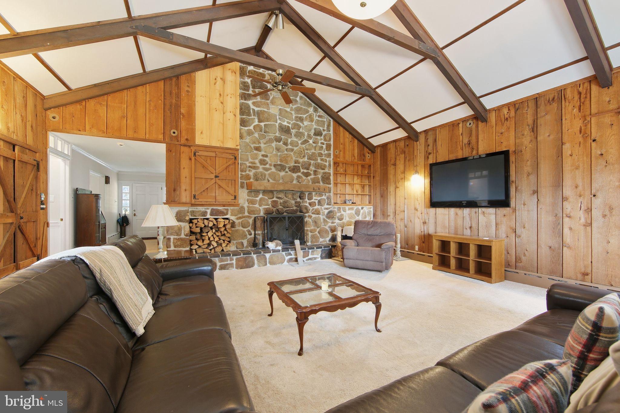 156 Grove Road Elverson, PA 19520 - Photo 15 of 45 a living room with furniture and a flat screen tv