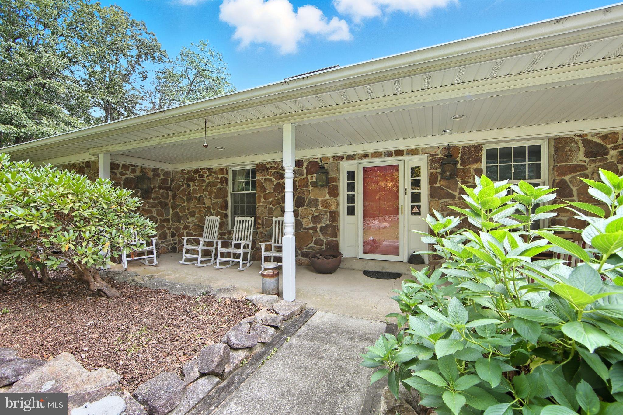 156 Grove Road Elverson, PA 19520 - Photo 2 of 45 a view of a patio with table and chairs and potted plants