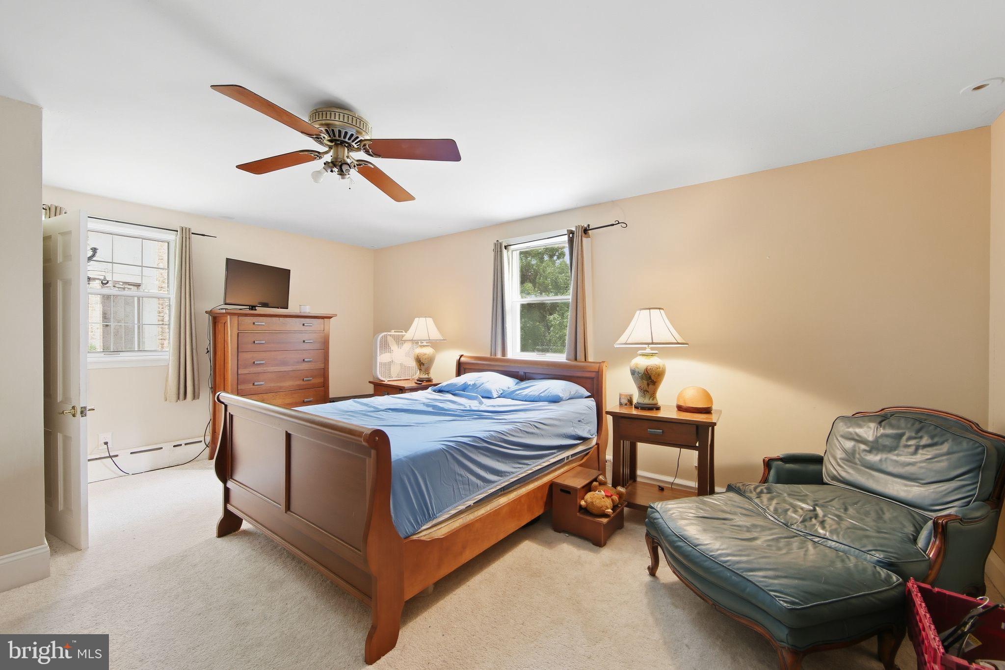 156 Grove Road Elverson, PA 19520 - Photo 22 of 45 a bedroom with a bed and wooden floor