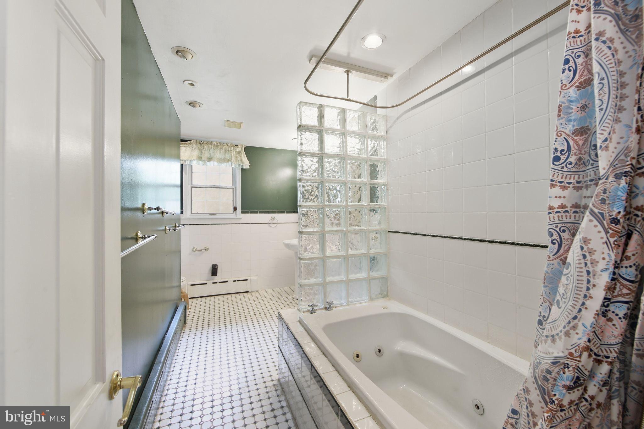 156 Grove Road Elverson, PA 19520 - Photo 25 of 45 a bathroom with a bathtub and a shower