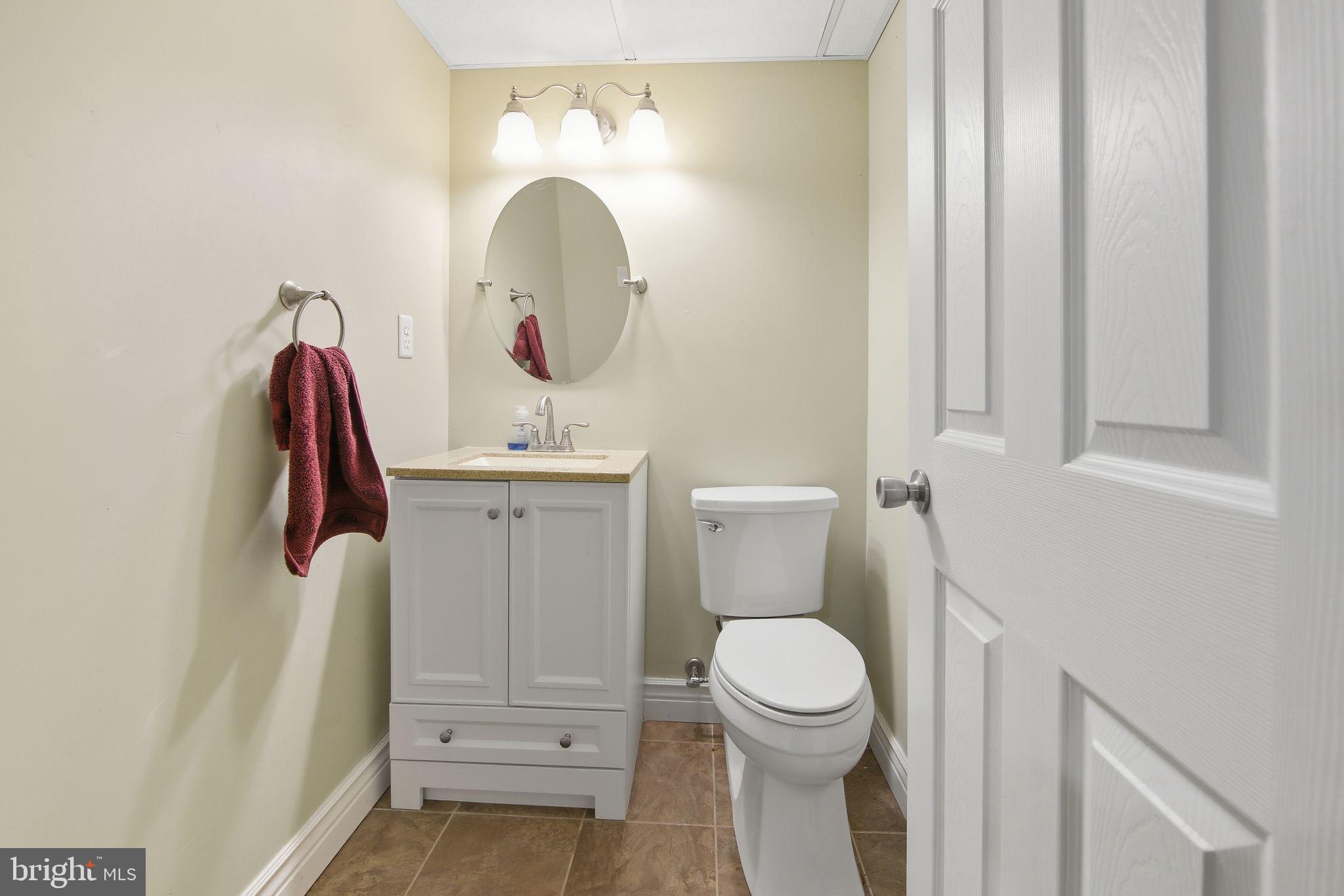 156 Grove Road Elverson, PA 19520 - Photo 28 of 45 a bathroom with a sink a toilet and a mirror