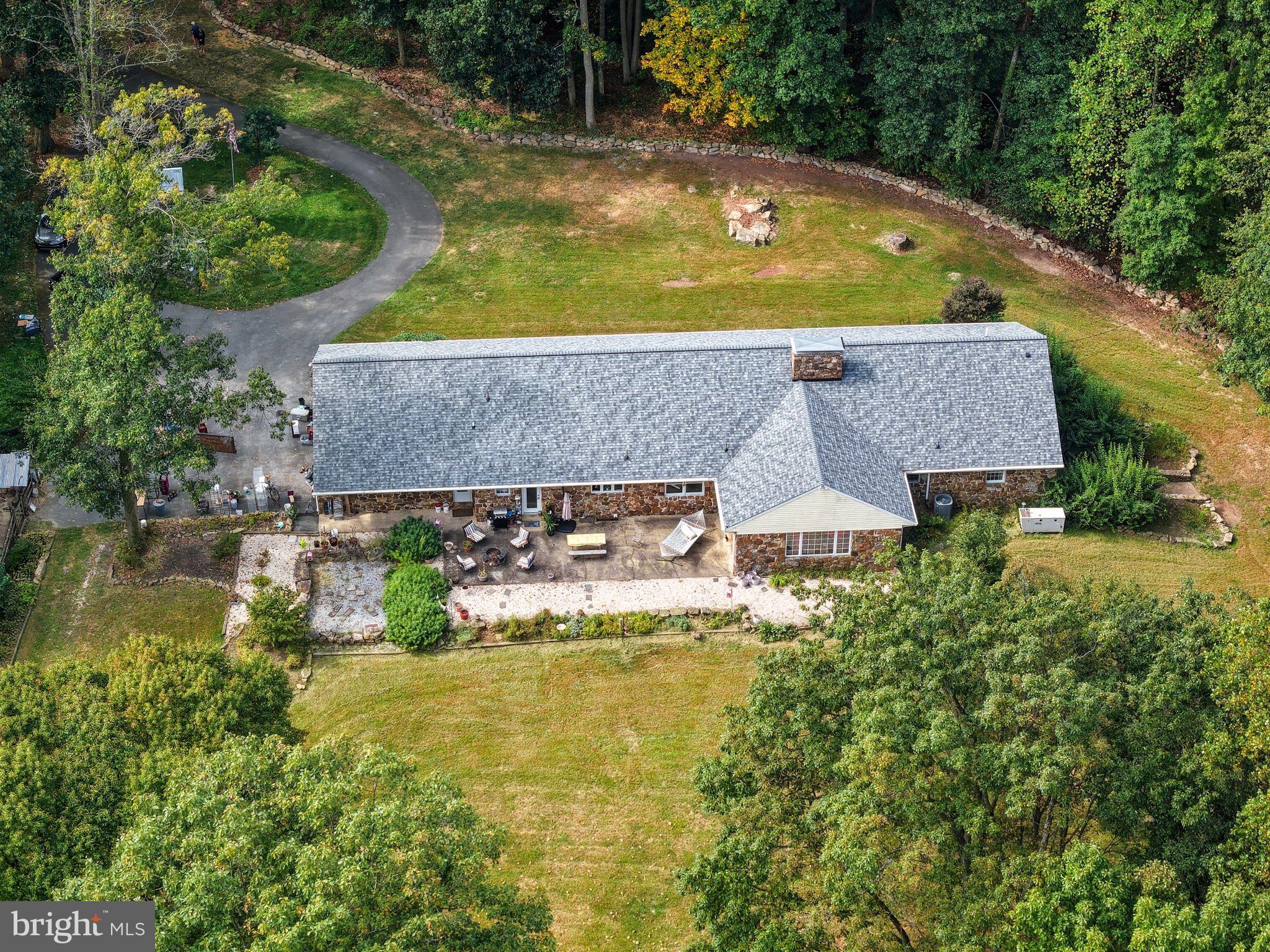 156 Grove Road Elverson, PA 19520 - Photo 44 of 45 an aerial view of a house with swimming pool and large trees