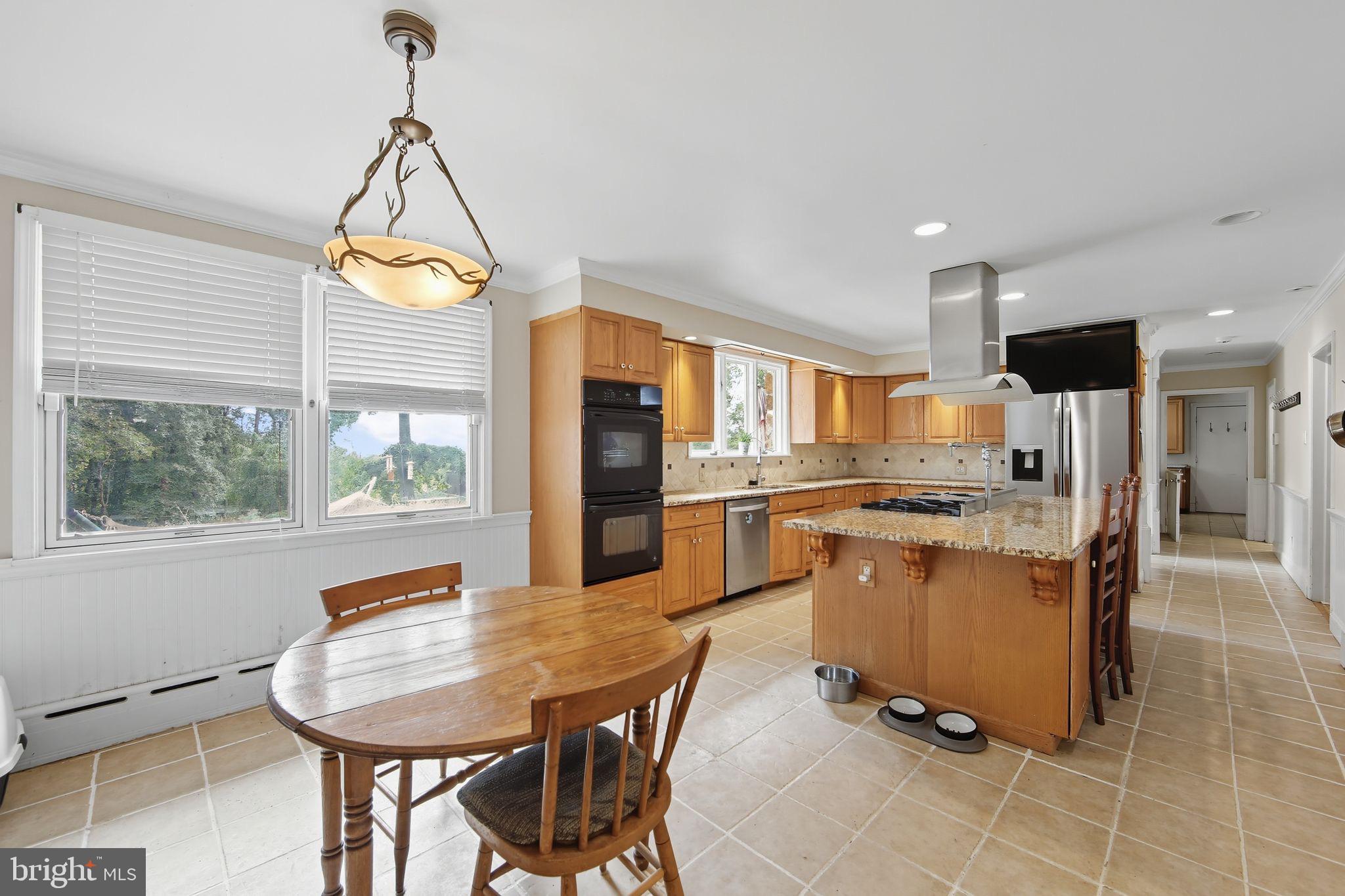 156 Grove Road Elverson, PA 19520 - Photo 5 of 45 a view of a dining room and livingroom with furniture wooden floor a chandelier