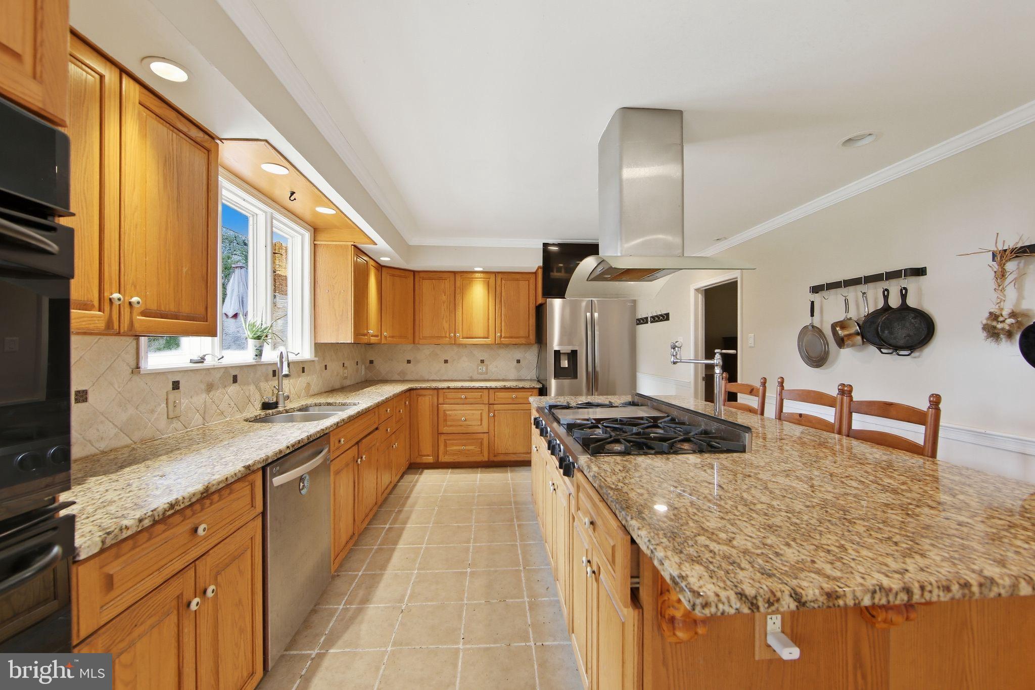 156 Grove Road Elverson, PA 19520 - Photo 7 of 45 a kitchen with stainless steel appliances granite countertop a sink stove and refrigerator