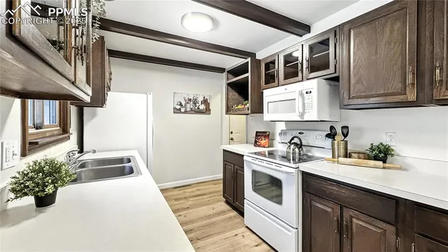 a kitchen with stainless steel appliances granite countertop a stove and a sink