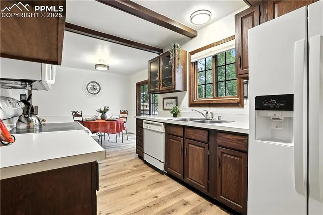 a kitchen with stainless steel appliances granite countertop a sink and cabinets