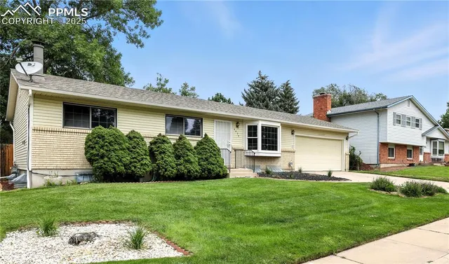 a front view of house with yard and green space