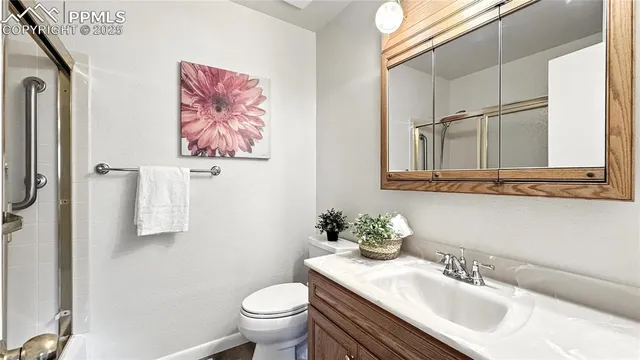 a bathroom with a sink toilet and mirror