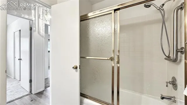 a bathroom with a glass shower door