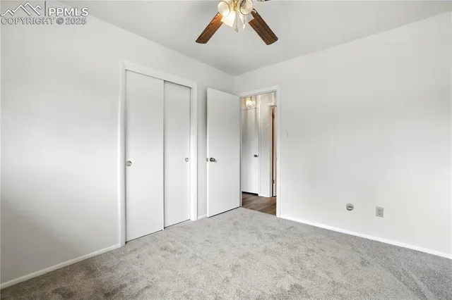 a view of a big room with a chandelier fan