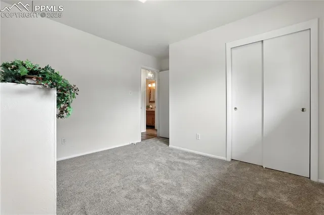 an empty room with potted plants in front of door