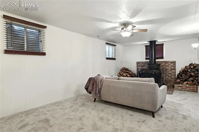 a living room with furniture a chandelier and a window
