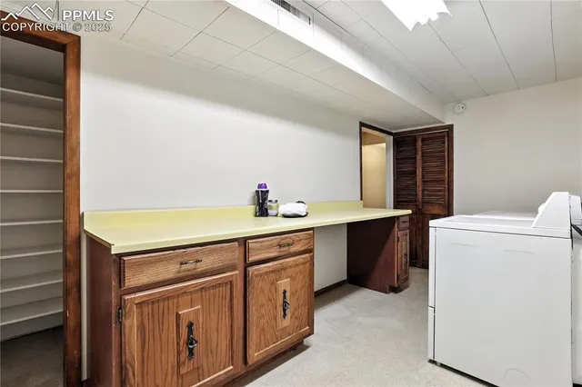 a room with a sink and a washer dryer
