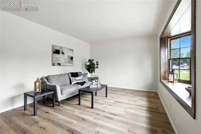 a living room with furniture and a window