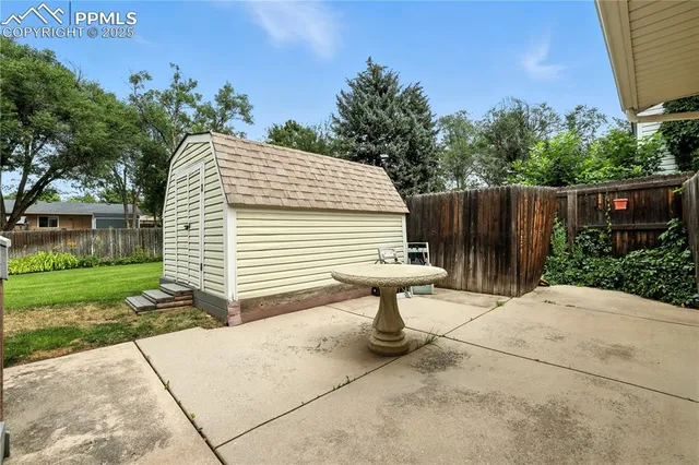 a front view of a house with garden and trees