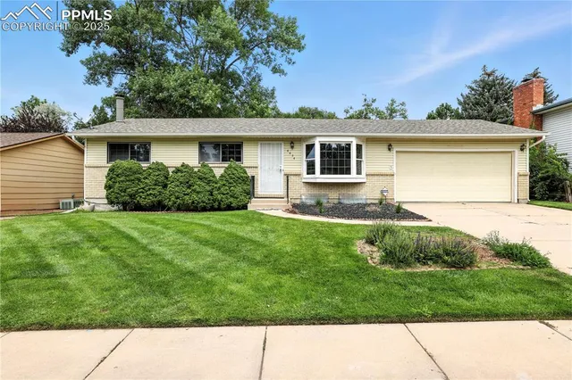 a backyard of a house with potted plants and wooden fence