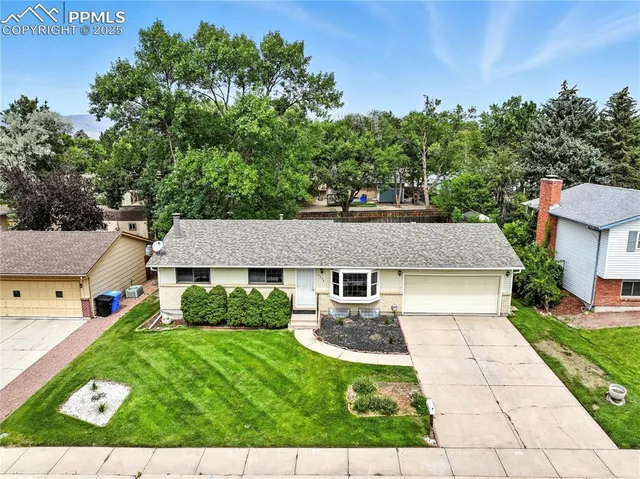 a aerial view of a house with a yard