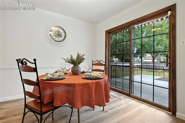 a dining room with furniture a rug and a large window
