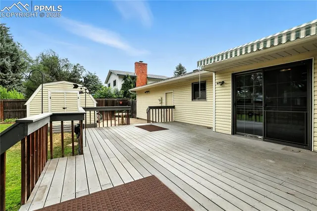 a view of a house with wooden deck