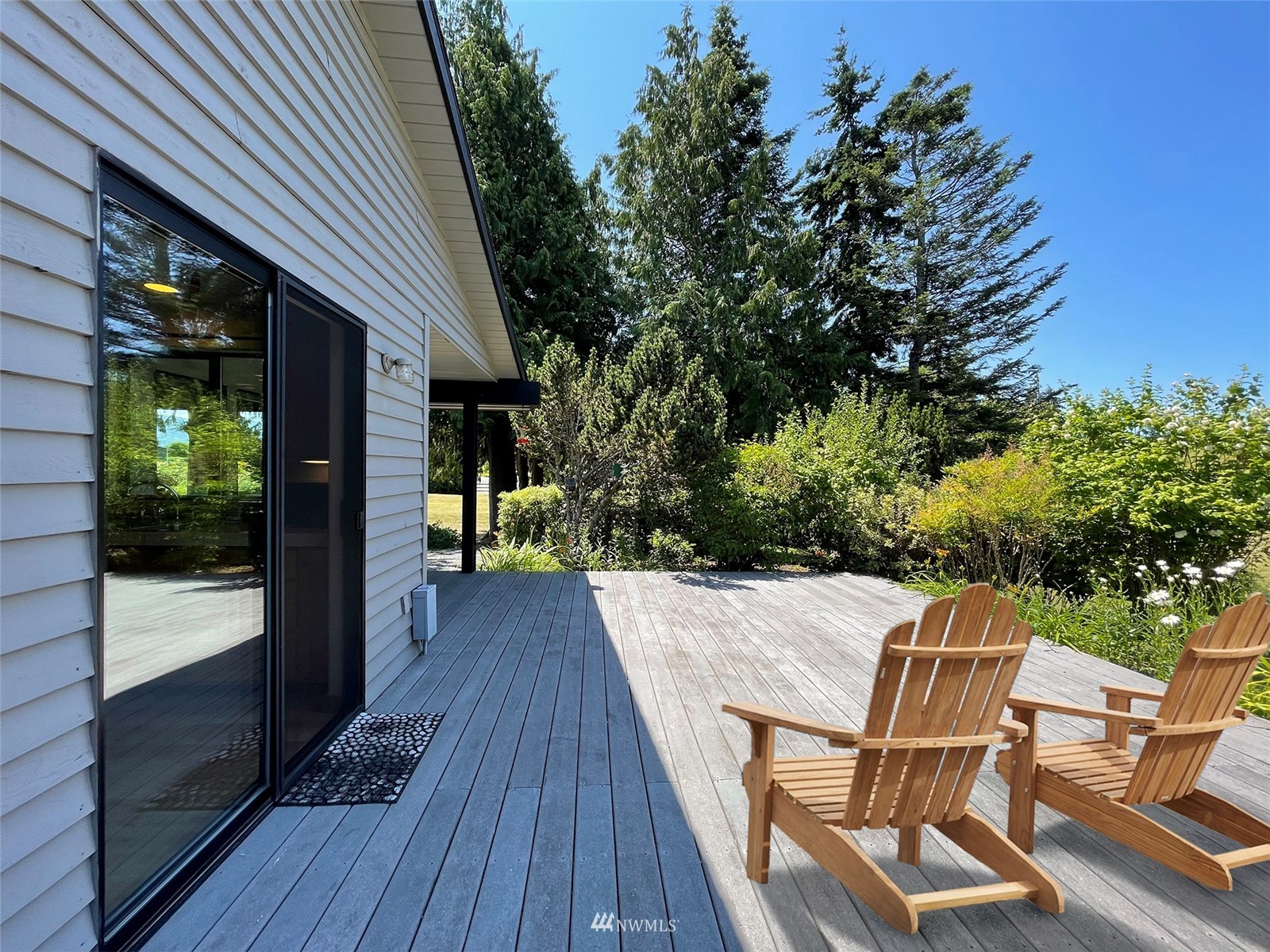 91 West Hidden Ridge Road Sequim, WA 98382 - Photo 15 of 40 a view of a chairs and table on the wooden deck