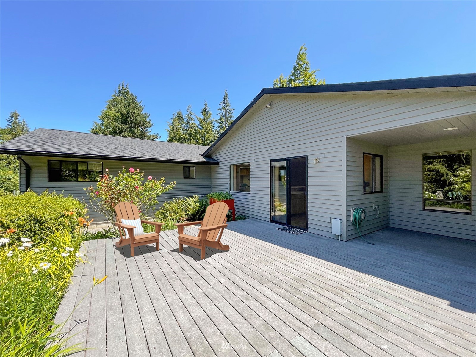 91 West Hidden Ridge Road Sequim, WA 98382 - Photo 16 of 40 a view of a patio with table and chairs and wooden floor