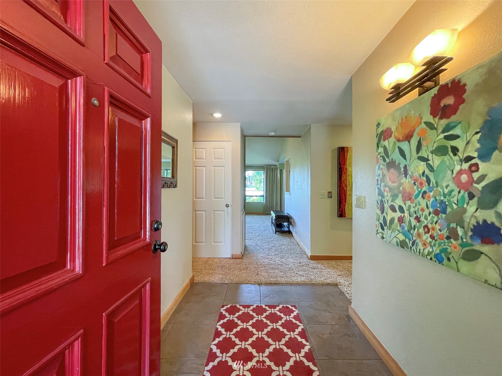 91 West Hidden Ridge Road Sequim, WA 98382 - Photo 6 of 40 a view of a hallway to a livingroom with furniture and toys