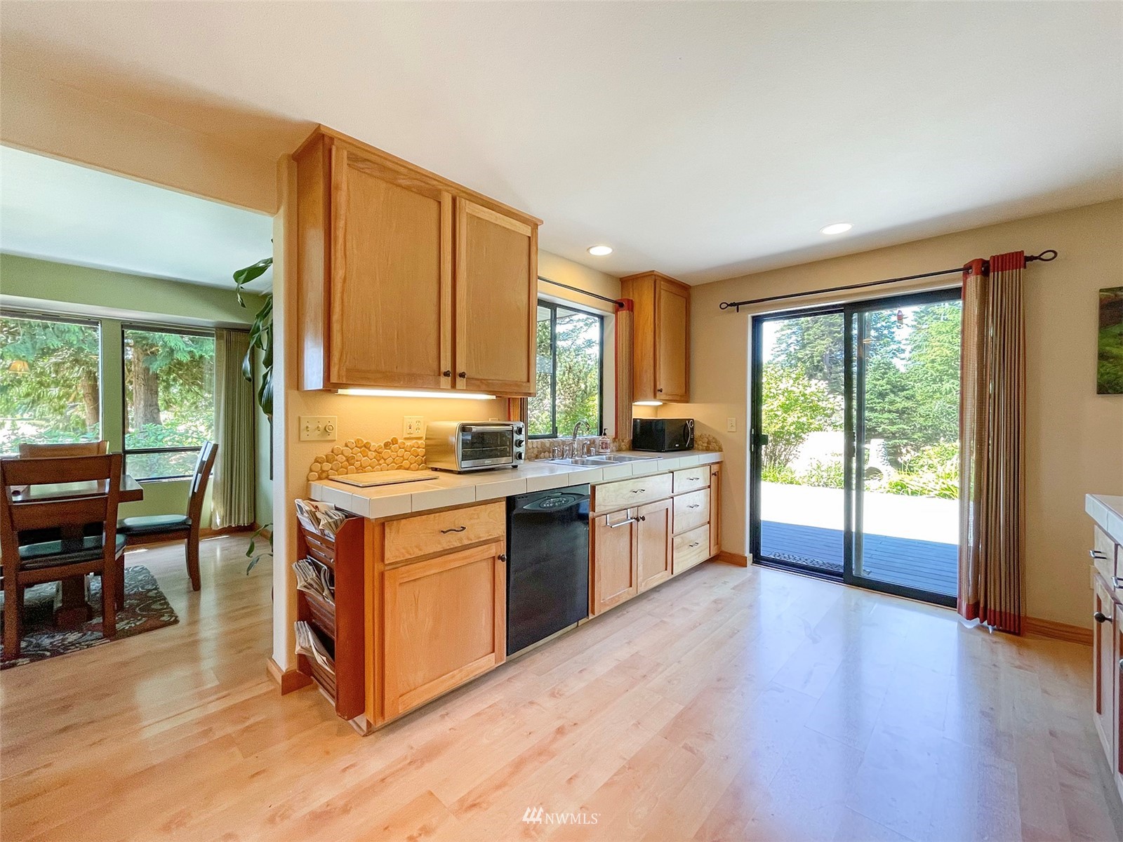 91 West Hidden Ridge Road Sequim, WA 98382 - Photo 8 of 40 a kitchen with a stove a sink and a refrigerator