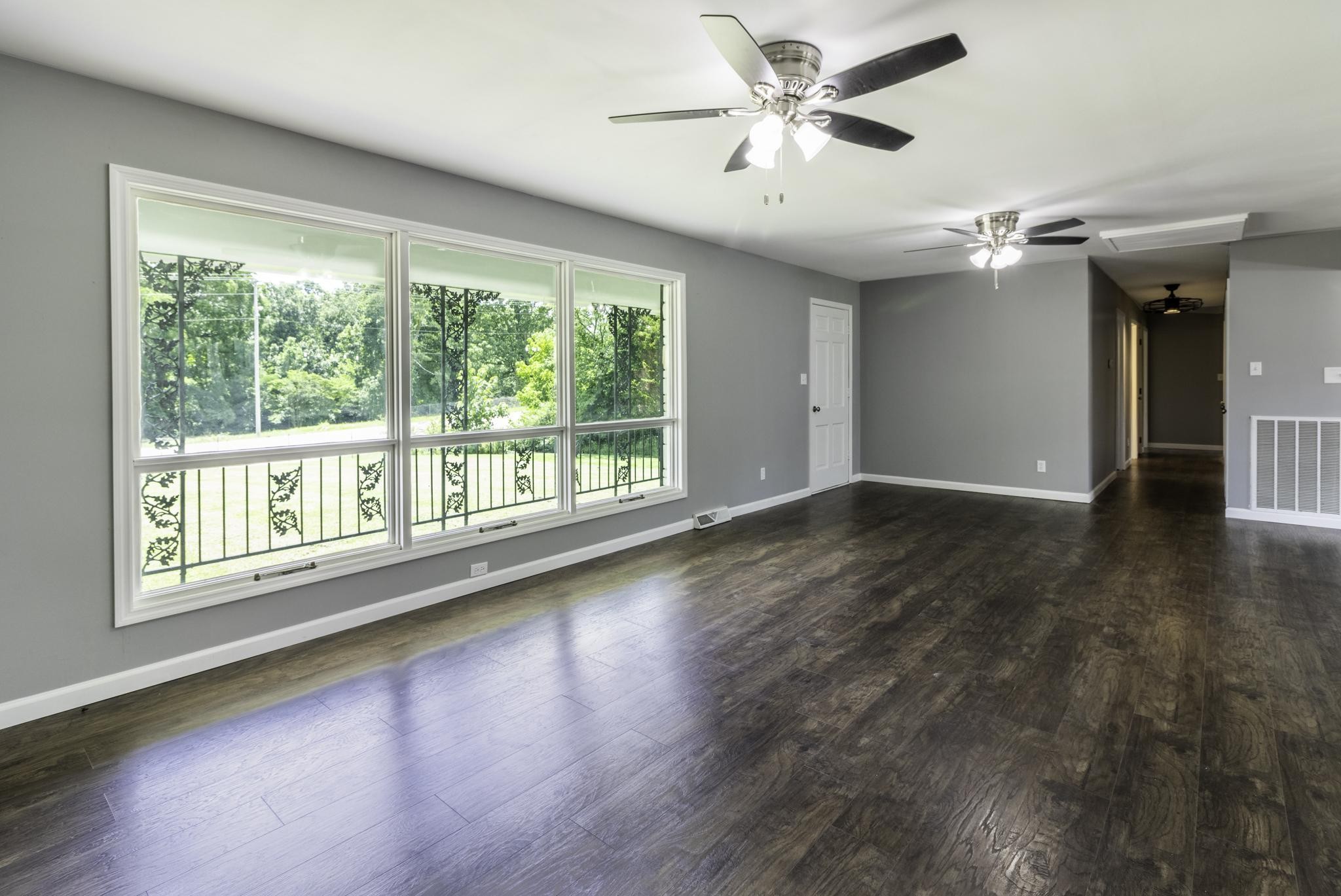 407 West Point Road Lawrenceburg, TN 38464 - Photo 3 of 36 a view of an empty room with a window and wooden floor
