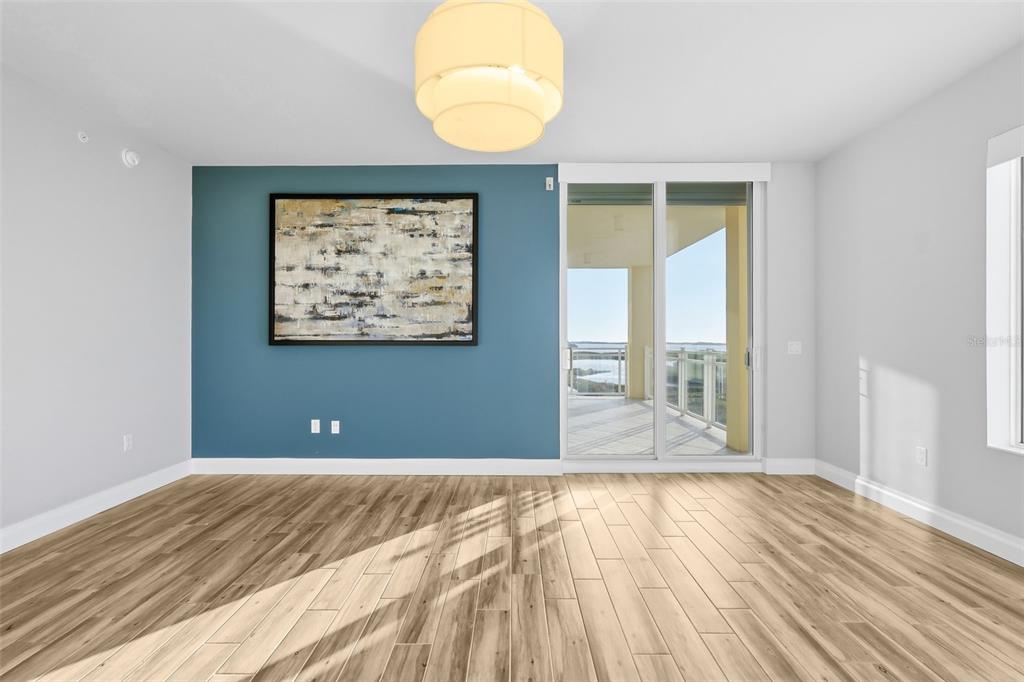 800 Collany Road, Unit 302 St. Petersburg, FL 33715 - Photo 54 of 66 an empty room with wooden floor and windows