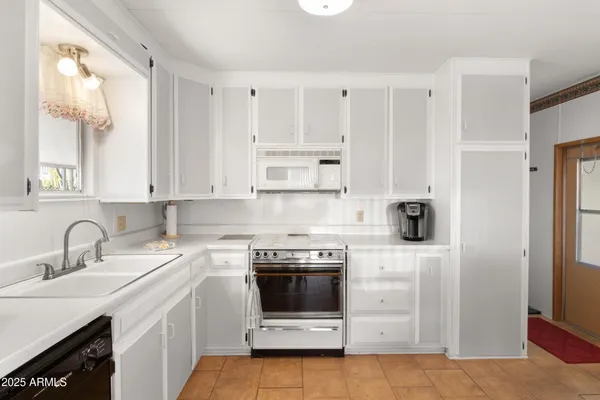 a kitchen with stainless steel appliances granite countertop a refrigerator and a stove