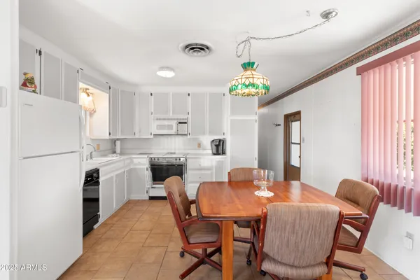 a kitchen with a refrigerator and a stove top oven