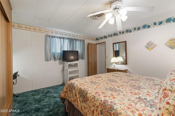 a bedroom with a bed and a chandelier