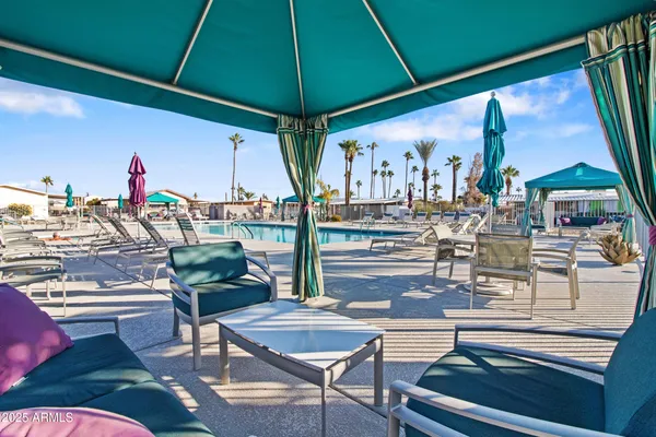 a view of a house with swimming pool and sitting area