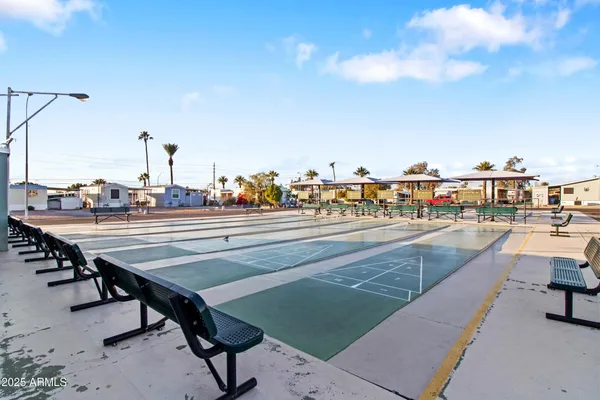 a large kitchen with kitchen island a island a stove a table and a sink