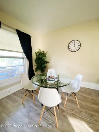 a view of a room that has a table and chair