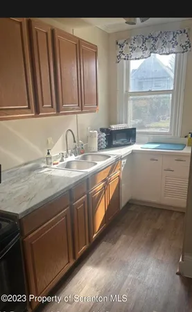 a kitchen with a sink window and cabinets