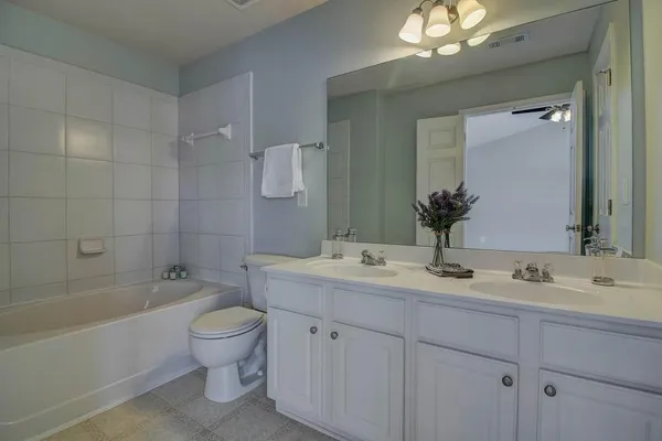 a bathroom with a sink a toilet and bathtub