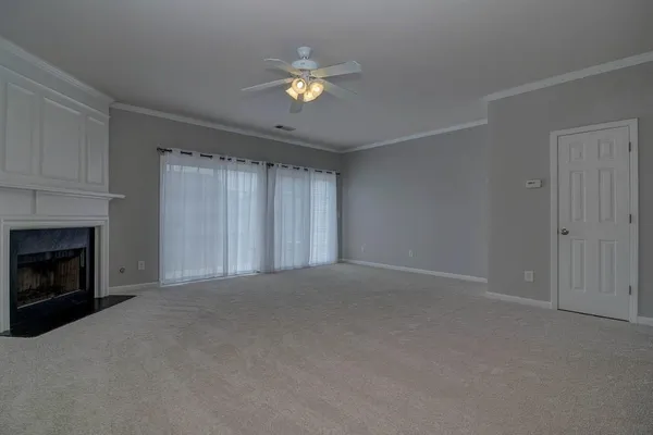 a view of an empty room with a fireplace