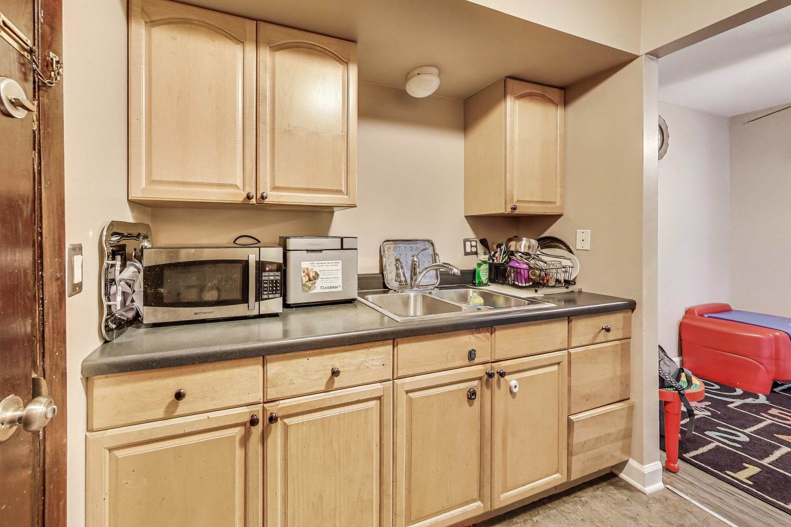 5113 North East River Road, Unit 1M Chicago, IL 60656 - Photo 12 of 25 a kitchen with stainless steel appliances granite countertop a sink and cabinets