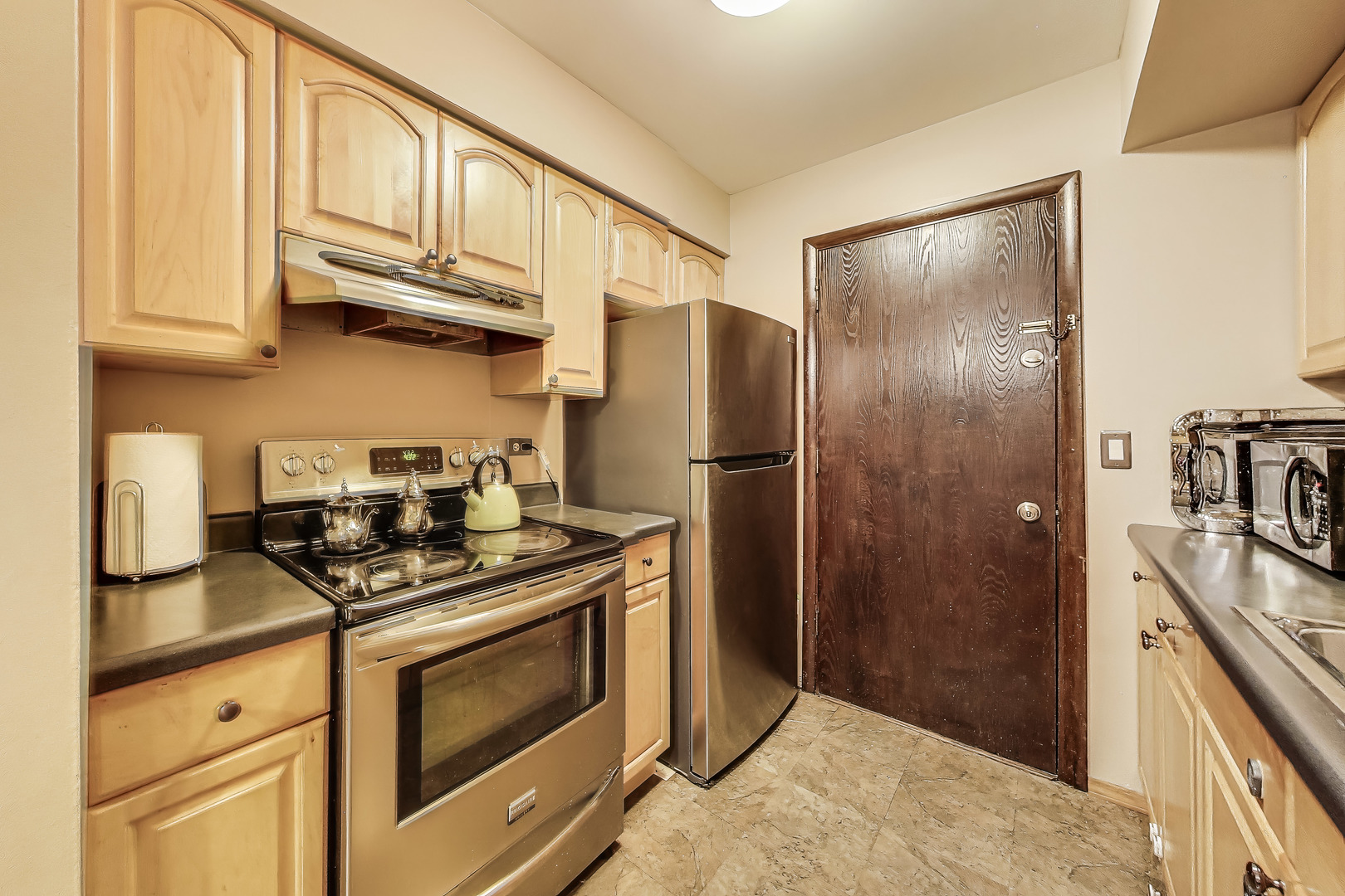 5113 North East River Road, Unit 1M Chicago, IL 60656 - Photo 13 of 25 a kitchen with stainless steel appliances granite countertop a stove a refrigerator and a cabinets