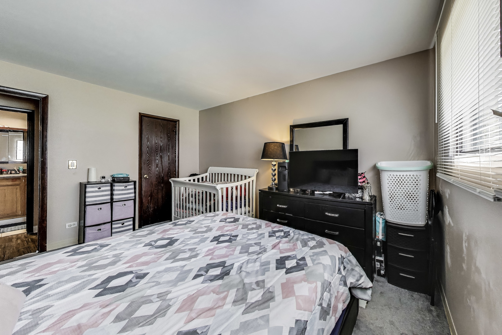 5113 North East River Road, Unit 1M Chicago, IL 60656 - Photo 16 of 25 a bedroom with a bed and a flat screen tv