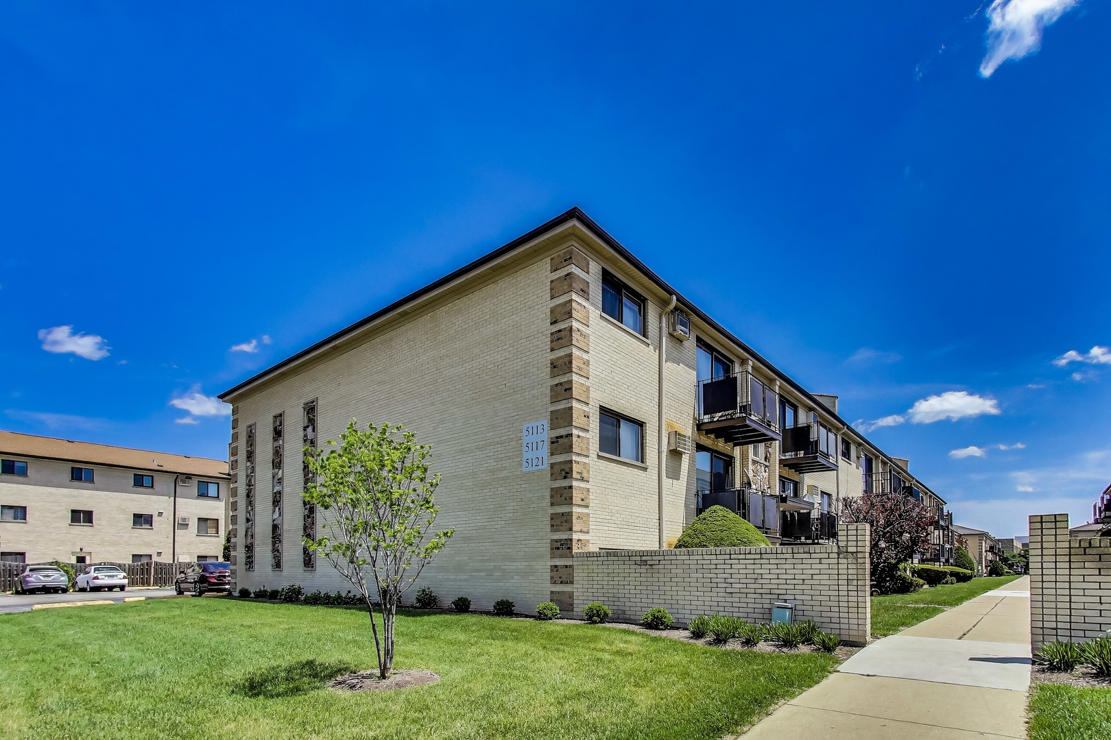 5113 North East River Road, Unit 1M Chicago, IL 60656 - Photo 2 of 25 a front view of a house with a yard